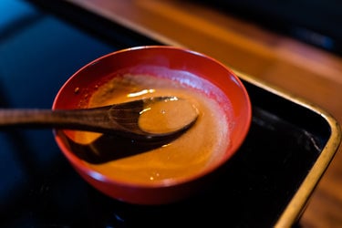 miso paste on a wooden spoon in a small bowl