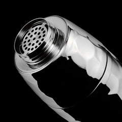 Chrome hexclad cocktail shaker open top on a black background