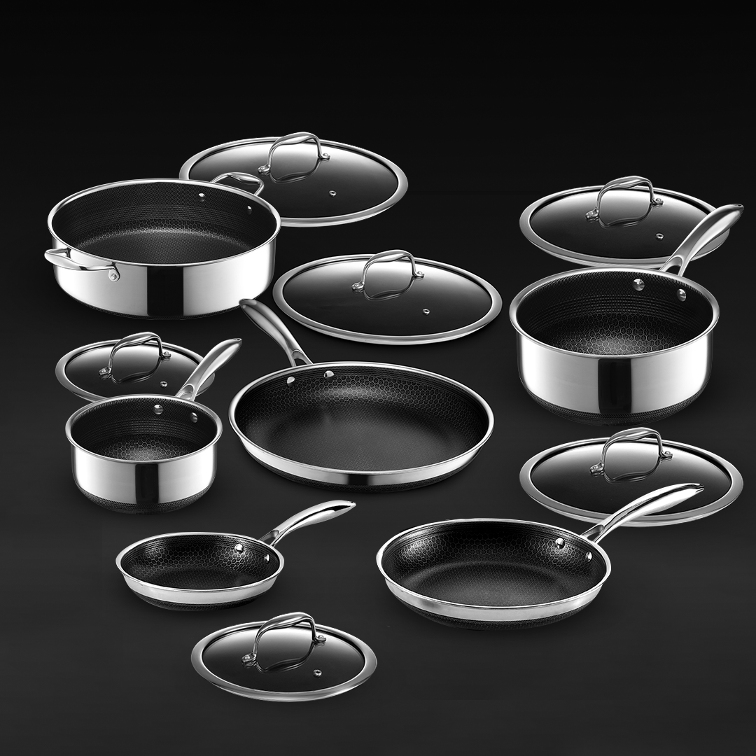 Stainless steel cookware set with black textured interiors and matching lids.